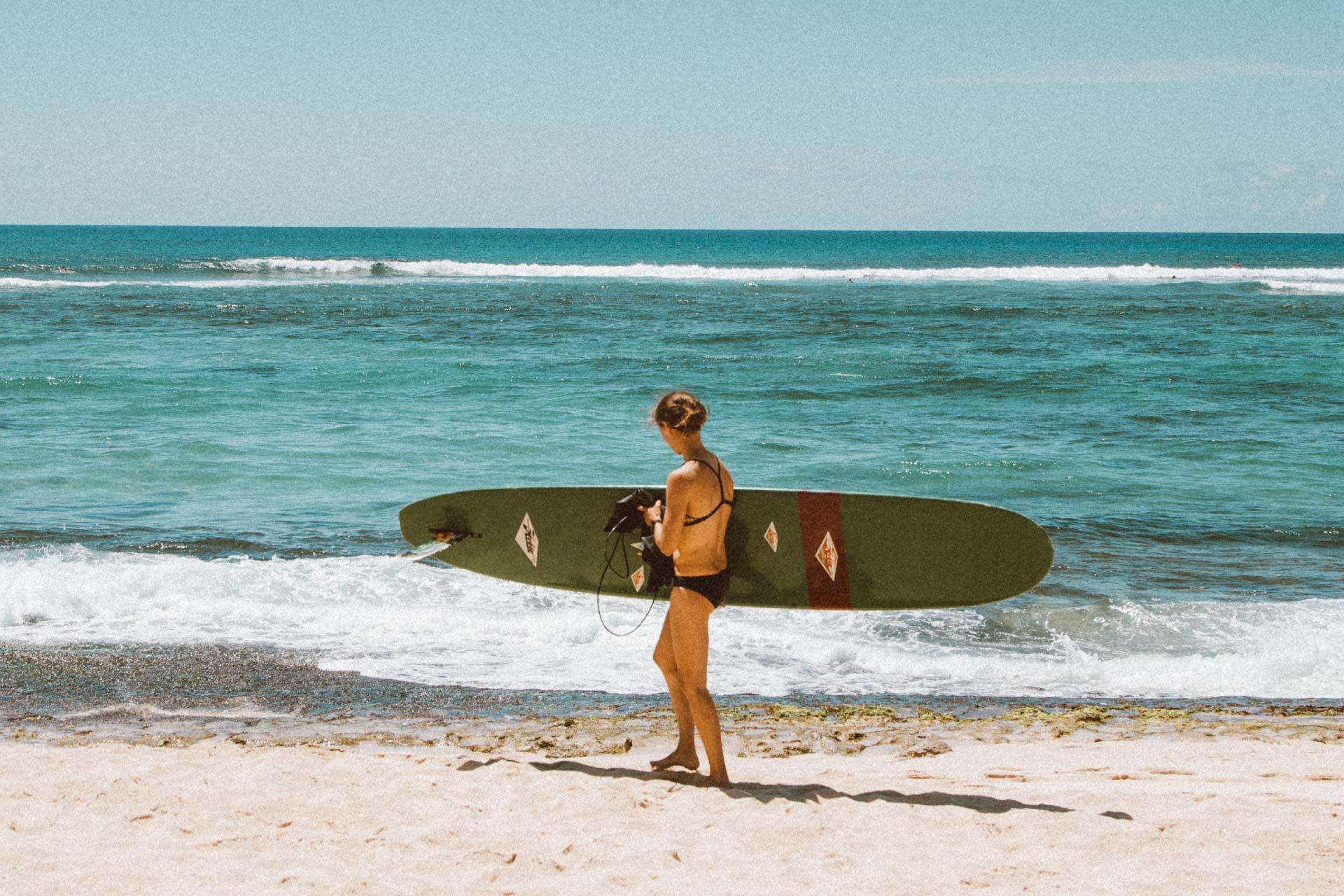 woman-with-surfboard-on-hawaii-beach